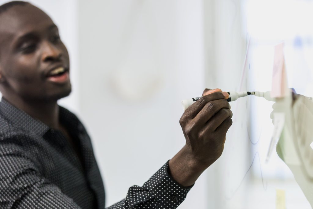 Man writes on whiteboard